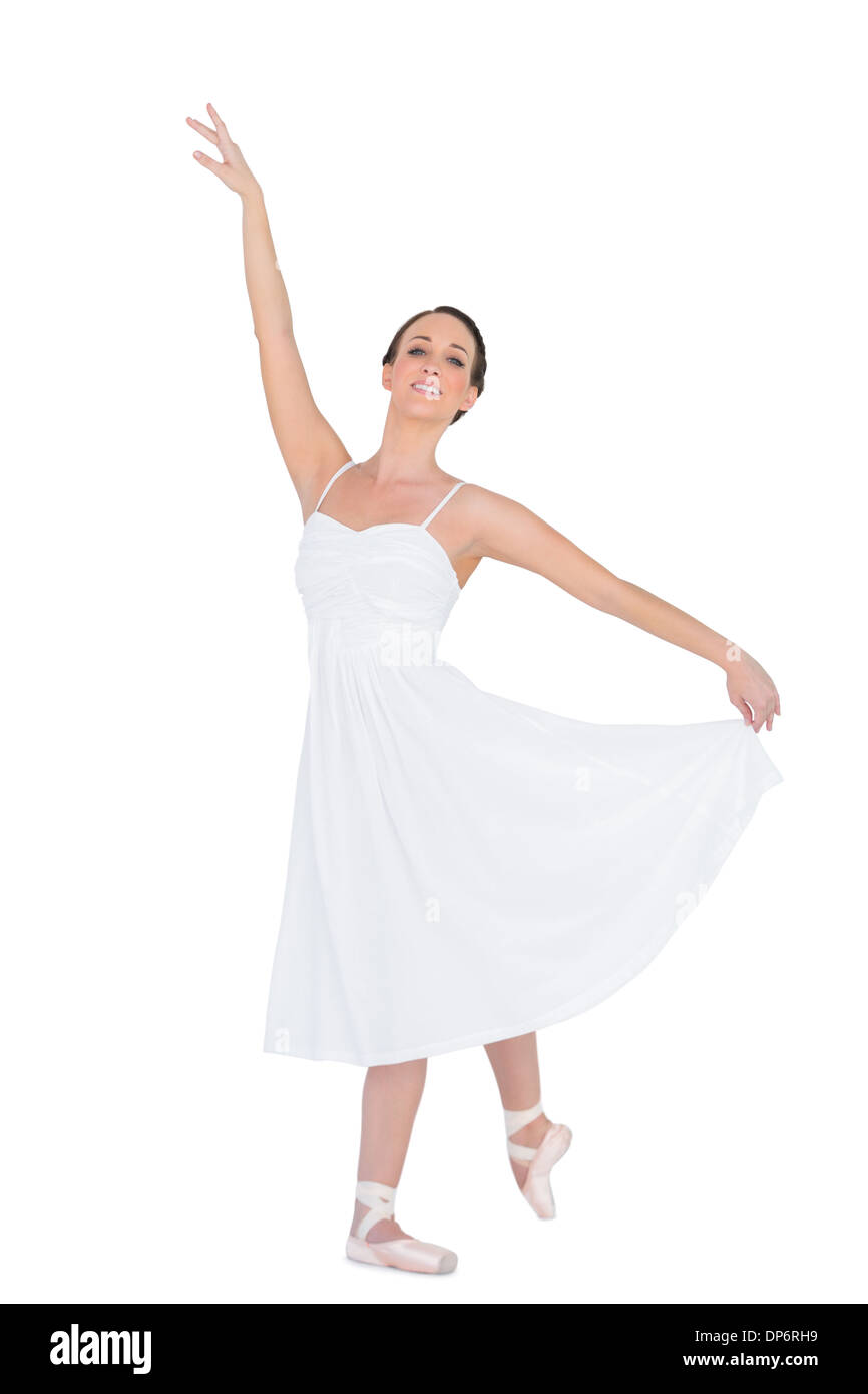Smiling young ballet dancer posing with her leg back Stock Photo