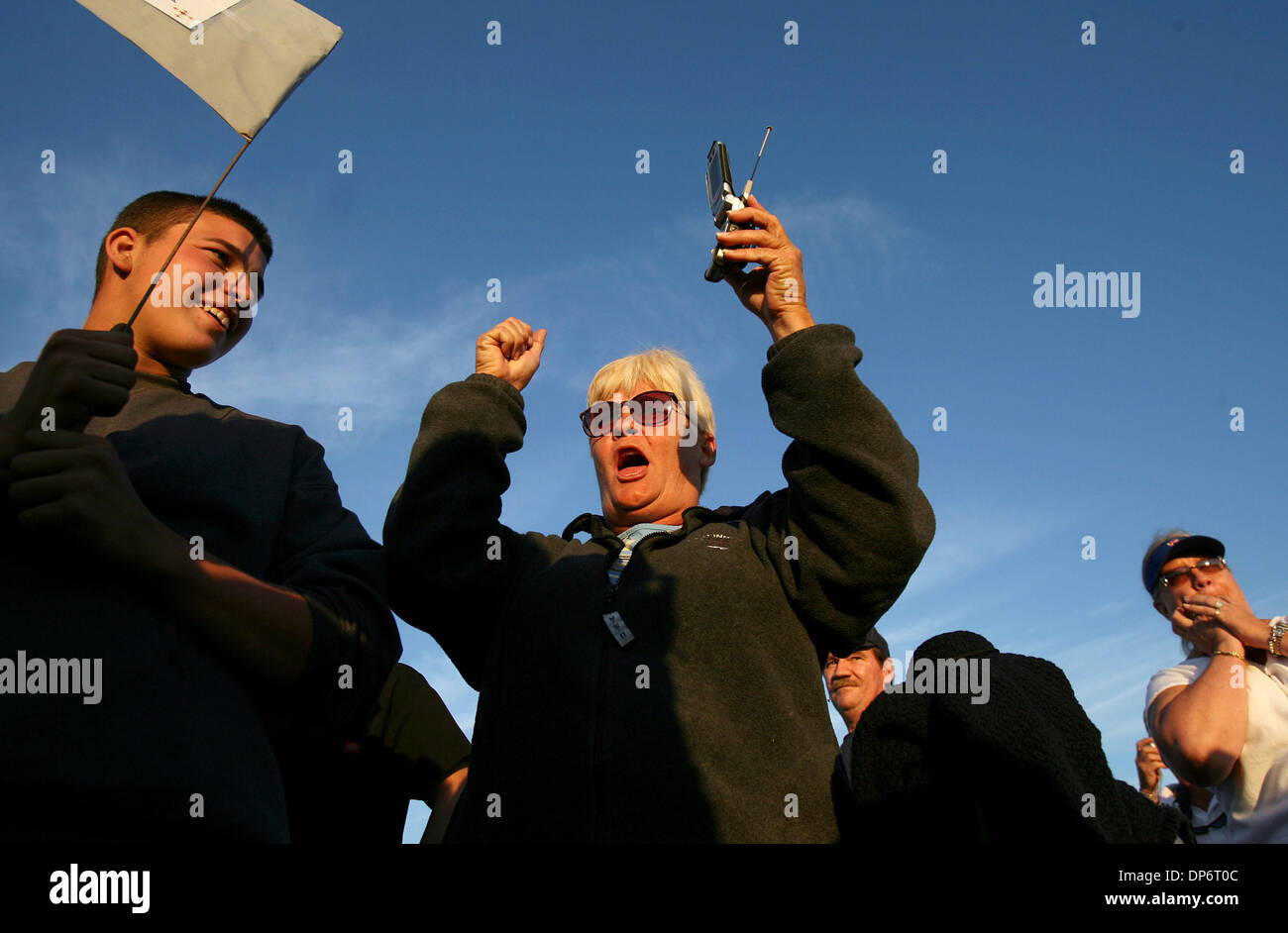 Oct 25, 2006; Starke, FL, USA; Cathy Davis (center) of Lake Butler cheers after hearing word of Danny Rolling's death.  Also shown are Davis' nephew, Charlie Cook, 19 (left) and Jane Hamby (right back) from Pamona Park.  Supporters and demonstrators gather outside of the Florida State Prison in Starke, where convicted serial killer Danny Rolling was executed by lethal injection on  Stock Photo