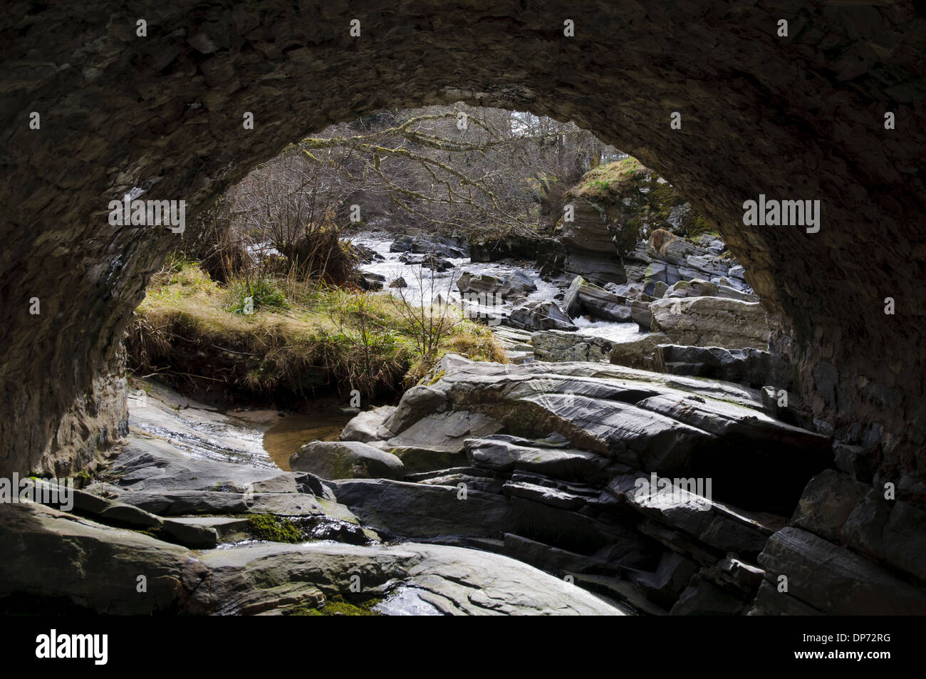 View of rocky river through bridge arch River Feshie Feshiebridge Cairngorms N.P. Inverness-shire Highlands Scotland March Stock Photo