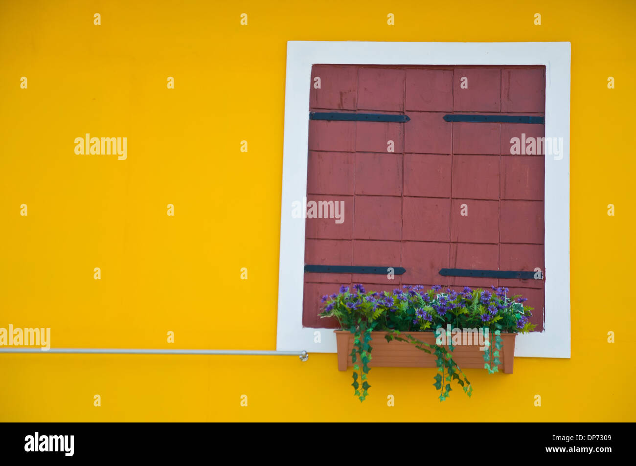 brown window frame on yellow background Stock Photo