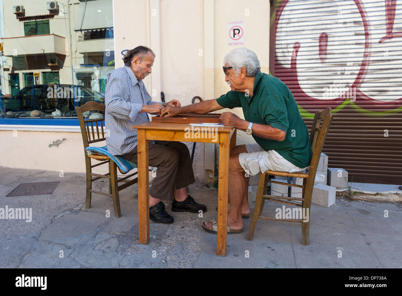 Two people playing traditional backgammon game in the streets of Chania