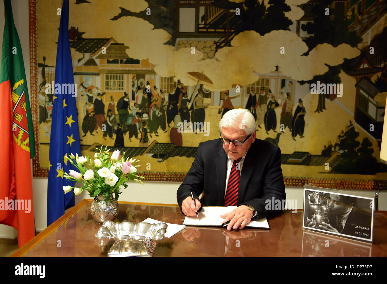 Berlin, Germany. January 8th 2014. Federal Minister for Foreign Affairs Frank-Walter Steinmeier (SPD) signs the condolence book in memory of the Portuguese football player Eusébio (aka Black Panther) in the Portuguese Embassy in Berlin. Goncalo Silva/Alamy Live News. Stock Photo