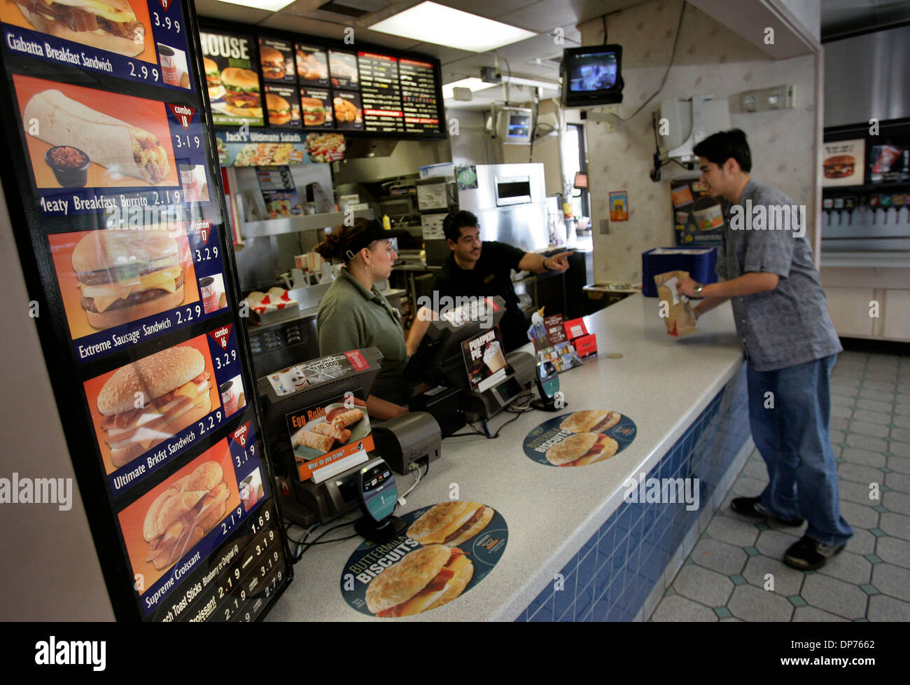 Nov 01, 2006; San Diego, CA, USA;  At the Jack In The Box restaurant on Hazard Center Drive JOANNA GARCIA, left, and manager JAIME CARMONA, center, serve PATRICK LIM, right, visiting from the Philippines his to go order of a Meaty Breakfast Burrito.  Mandatory Credit: Photo by Howard Lipin/SDU-T/ZUMA Press. (©) Copyright 2006 by SDU-T Stock Photo