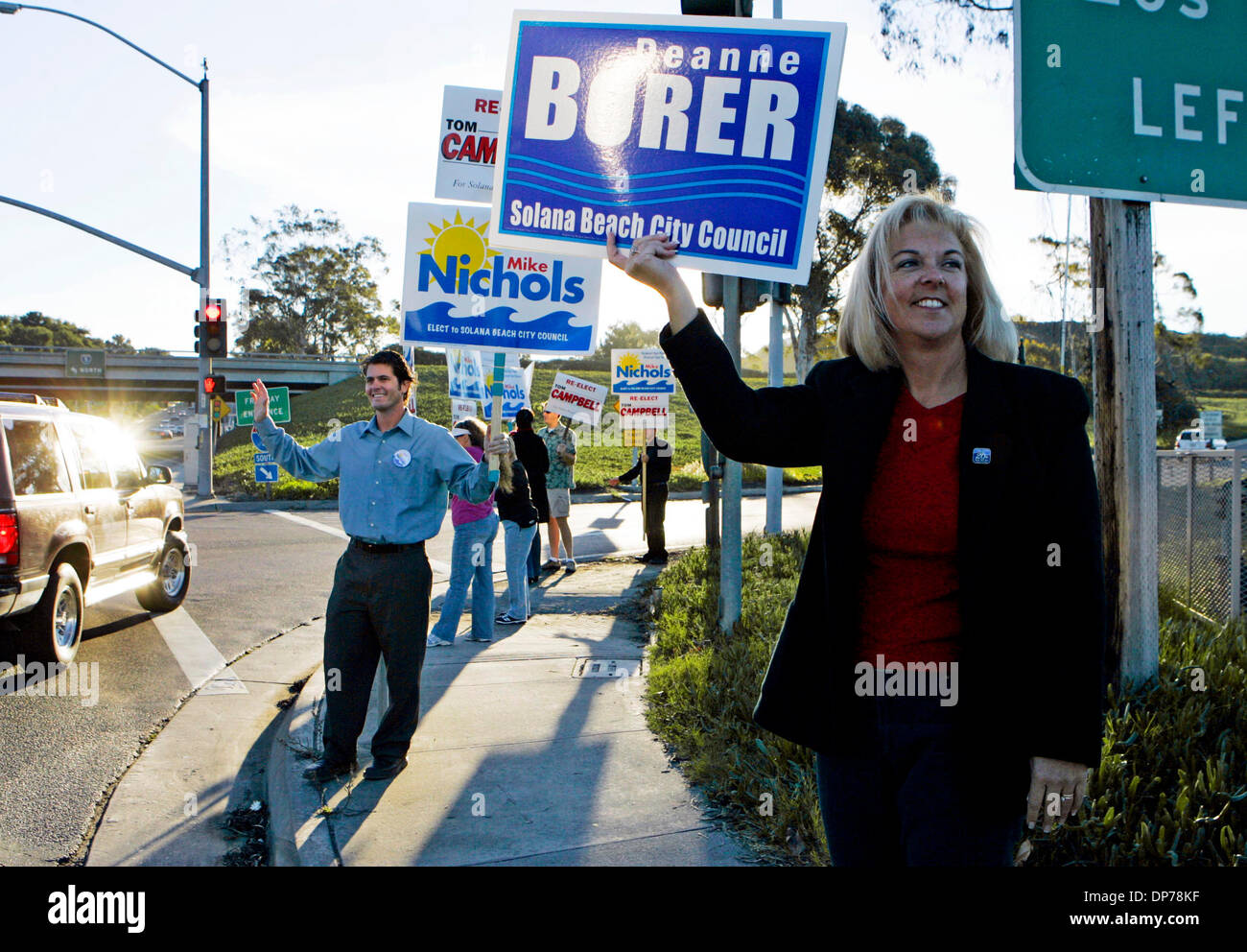 Nov 07, 2006; Solana Beach, CA, USA; MIKE NICHOLS, left, and DEANNE BORER,  right, both candidates for Solana Beach City Council, wave signs with their  names on them to drivers on Lomas