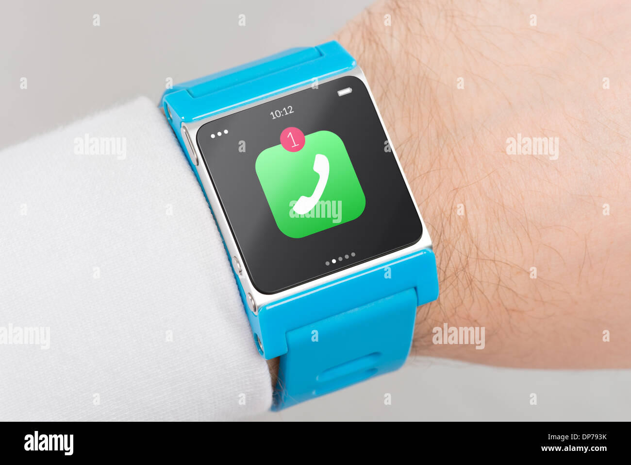 Close up blue smart watch with missed phone call icon on the screen is on hand Stock Photo