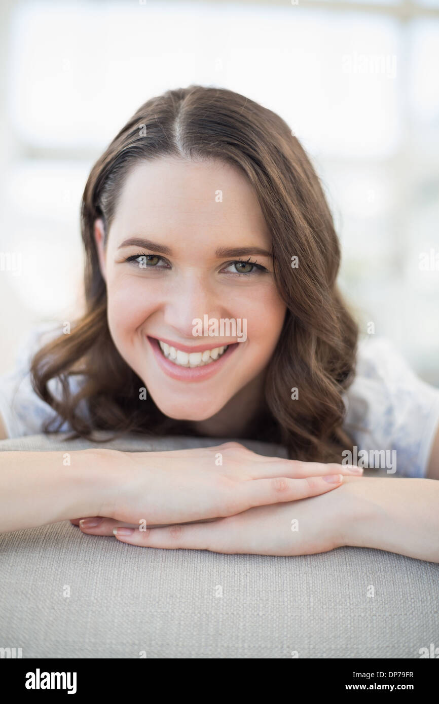 Close up on smiling pretty woman lying on a cosy couch Stock Photo - Alamy