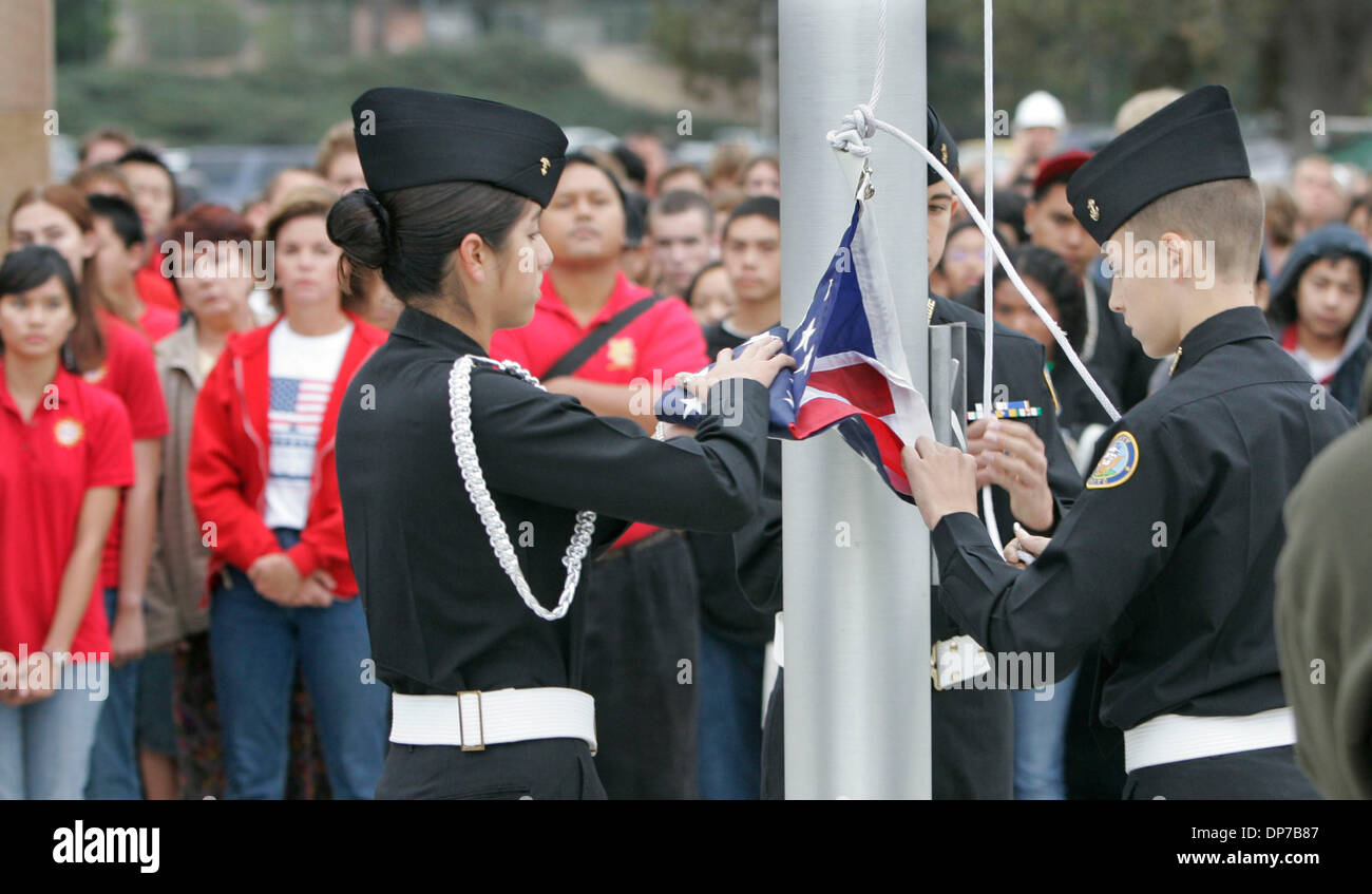 Nov 09, 2006; Rancho Penasquitos, CA, USA; Westview High School Navy Junior ROTC SARA ESCOBEDO prepares to raise the flag which was flown over Camp Eggers in Kabul, Afghanistan on Sept. 11 of this year, then sent to Mt. Carmel High School teacher and coach Chris Vitous by Lt. Col. David Guzman who was an assistant coach at the school before he was deployed in June. Behind the pole  Stock Photo