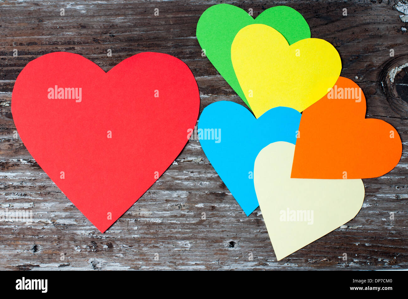 Different color paper hearts on an old wood Stock Photo Alamy