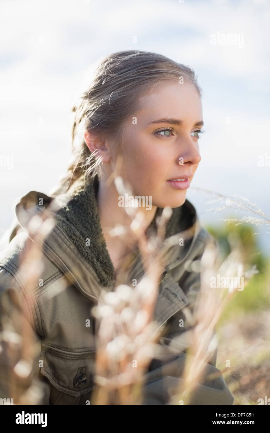 Beautiful woman sitting in grass Stock Photo - Alamy