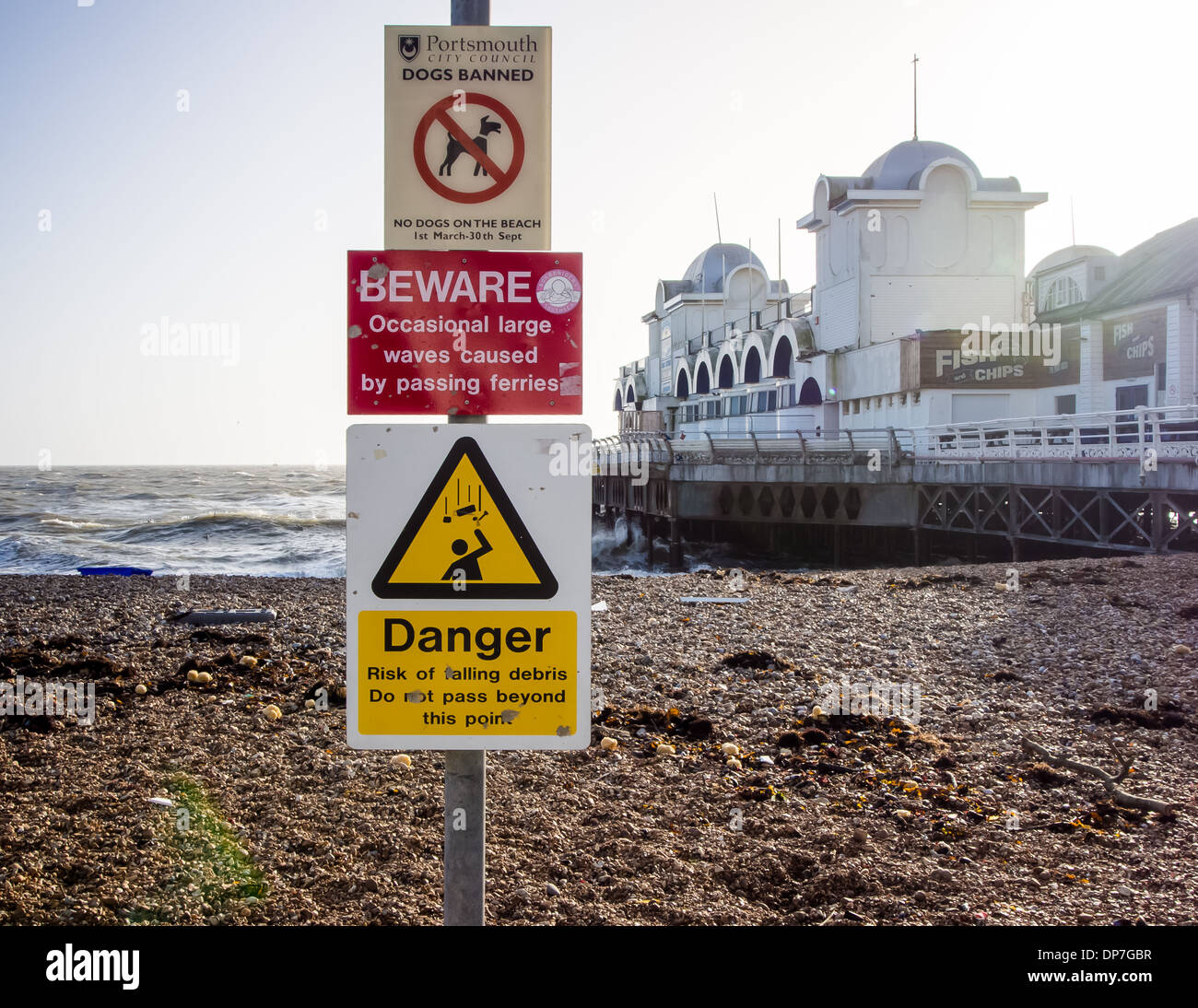 signs warning of dangers on the beach as well as declaring Dogs being banned beside South Parade Pier in Southsea Portsmouth Stock Photo