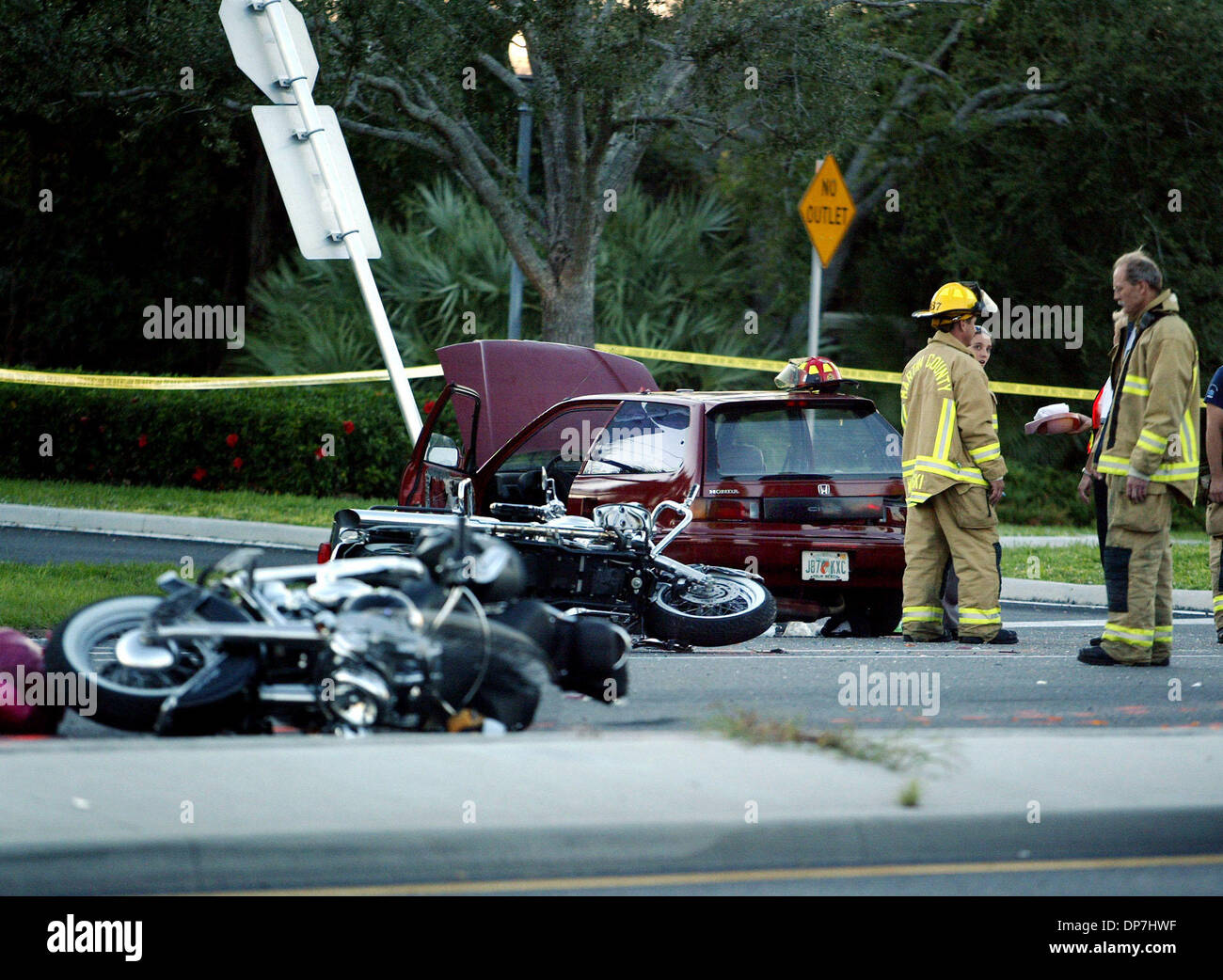 Nov 17, 2006; Hobe Sound, FL, USA; Martin County Fire Rescue workers stand near a red honda that