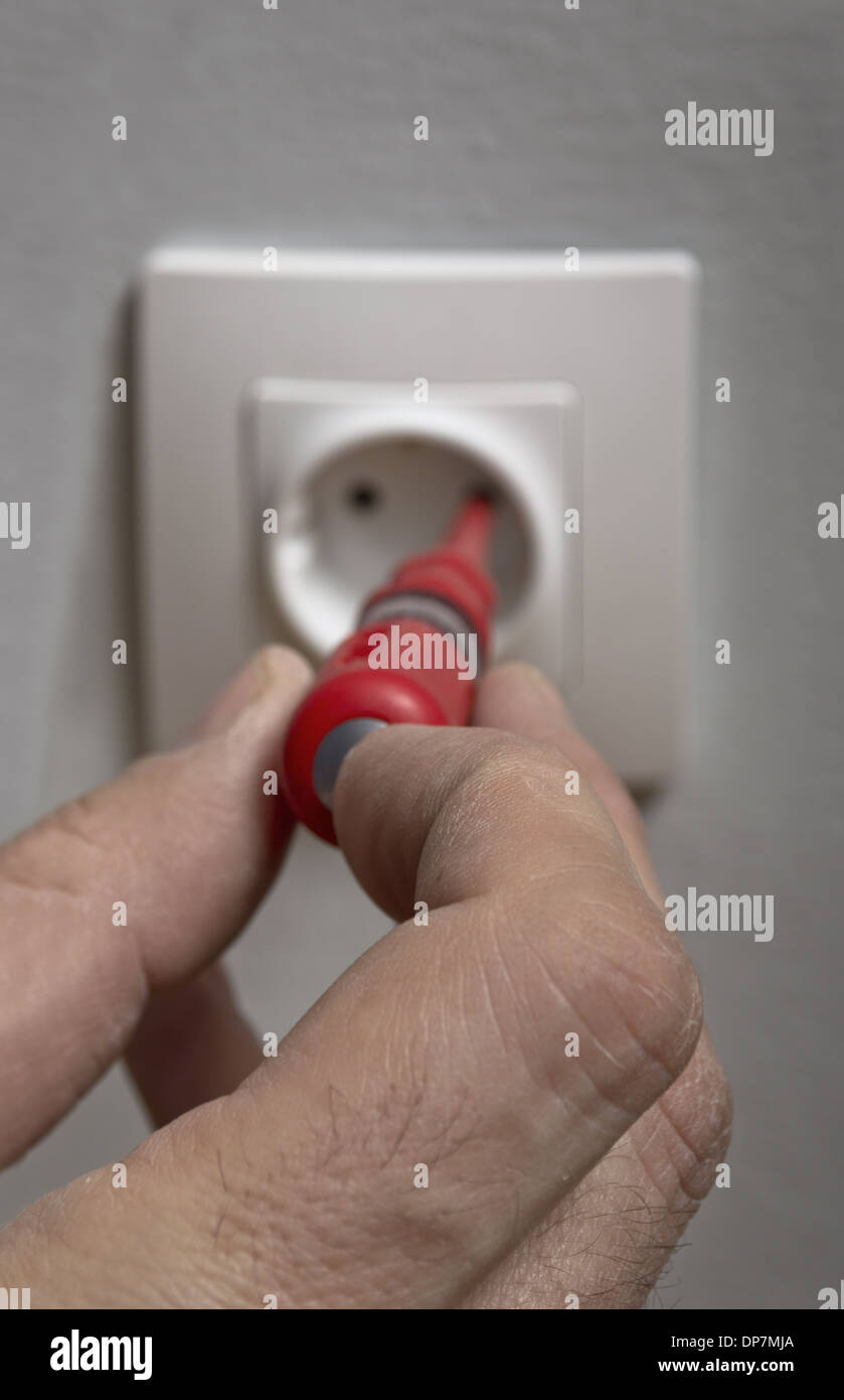 Electrician checking electric voltage on a plug outlet Stock Photo Alamy