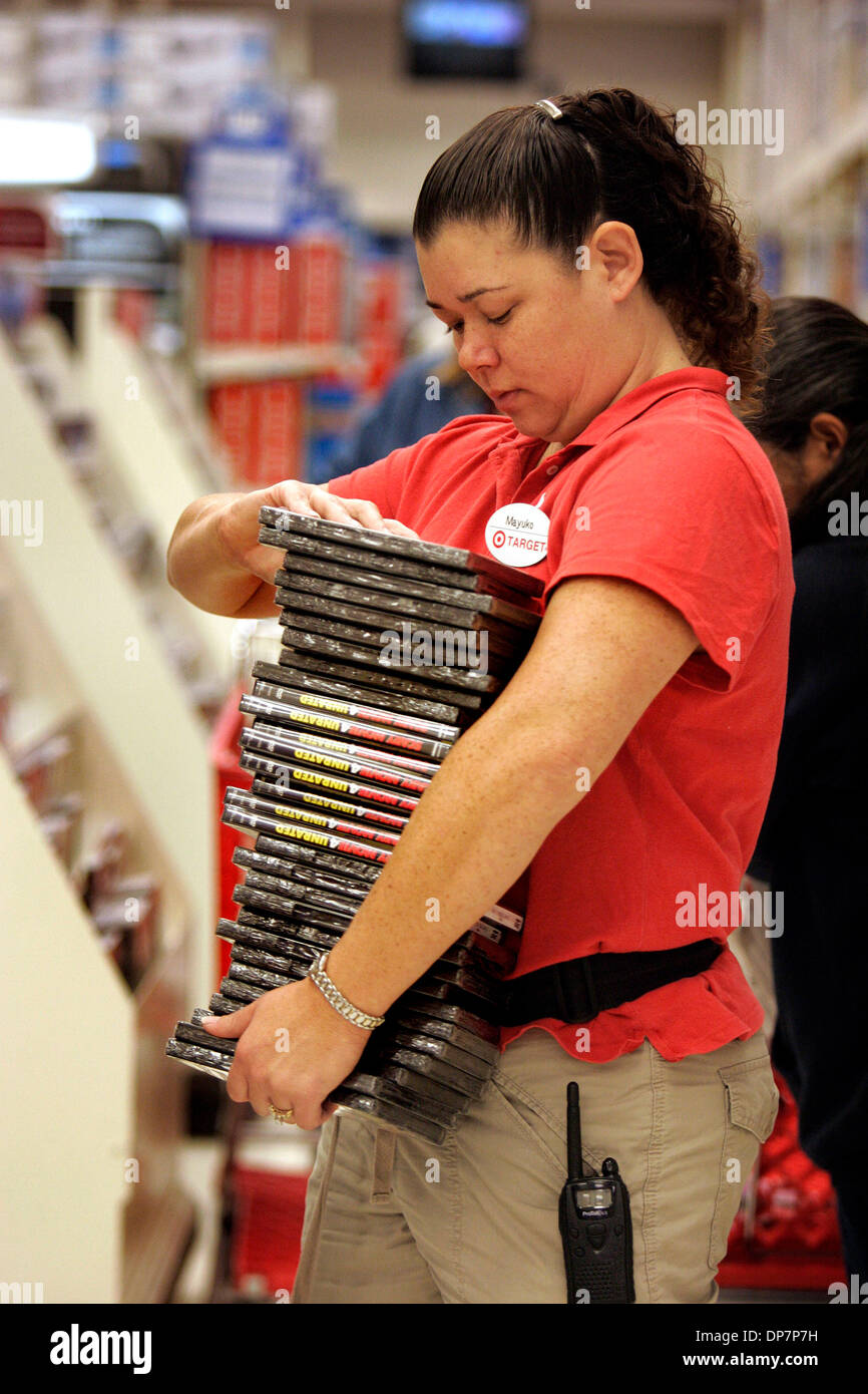 Nov 22, 2006; Encinitas, CA, USA; MAYUKO DIERICH, an employee of the Target Greatland store in Encinitas, restocks a load of 'Scary Movie 4' DVD's which were on sale Friday morning for $7.50 instead of  its normal $13.78 price.  Many shoppers lined up for deep discounts on certain items that were in limited quantity, like television sets and popular childrens toys. Mandatory Credit Stock Photo