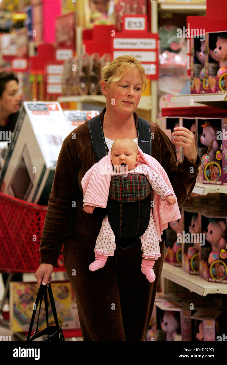 Nov 22, 2006; Encinitas, CA, USA; BRITTANY FIELD of Pleasant Hill, CA (near SF) shops with her 3-month-old daughter, Kate, in a baby carrier as she takes advantage of early morning deals at 6:06 a.m. Friday morning at the Target Greatland store in Encinitas, the day after Thanksgiving.  Field told me, 'Kate was already up at 5, so I thought I'd shop.'  Many lined up for deep discou Stock Photo