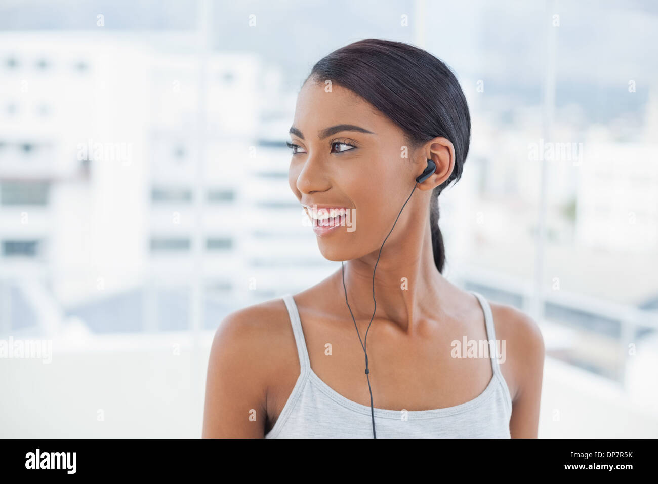 Smiling pretty model listening to music Stock Photo