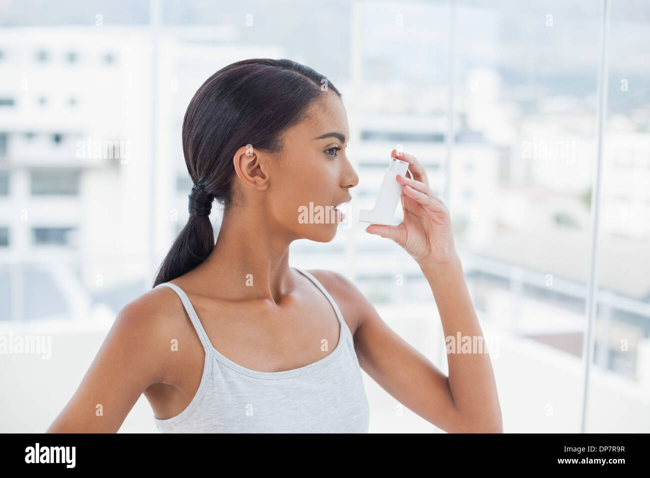 Pretty model using her asthma atomizer Stock Photo