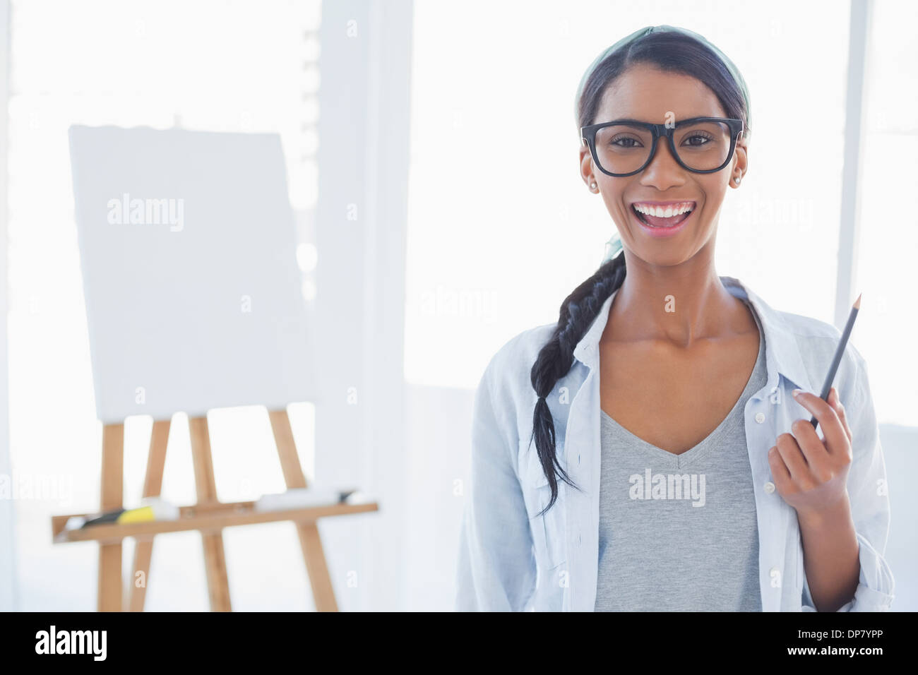Cheerful attractive artist holding drawing pencil Stock Photo - Alamy