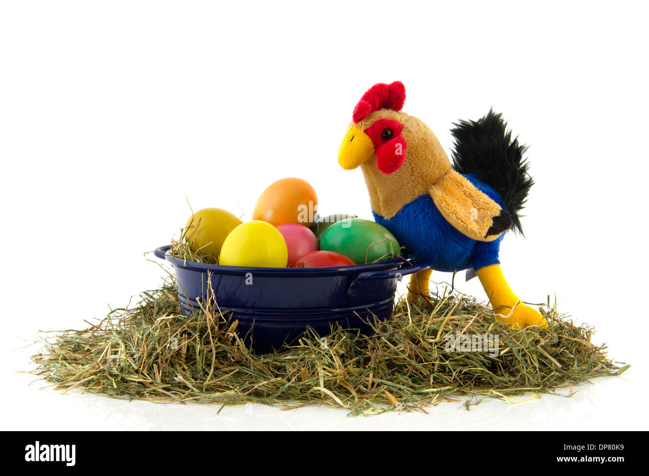 Blue bucket with straw and colorful painted easter eggs and chicken Stock Photo