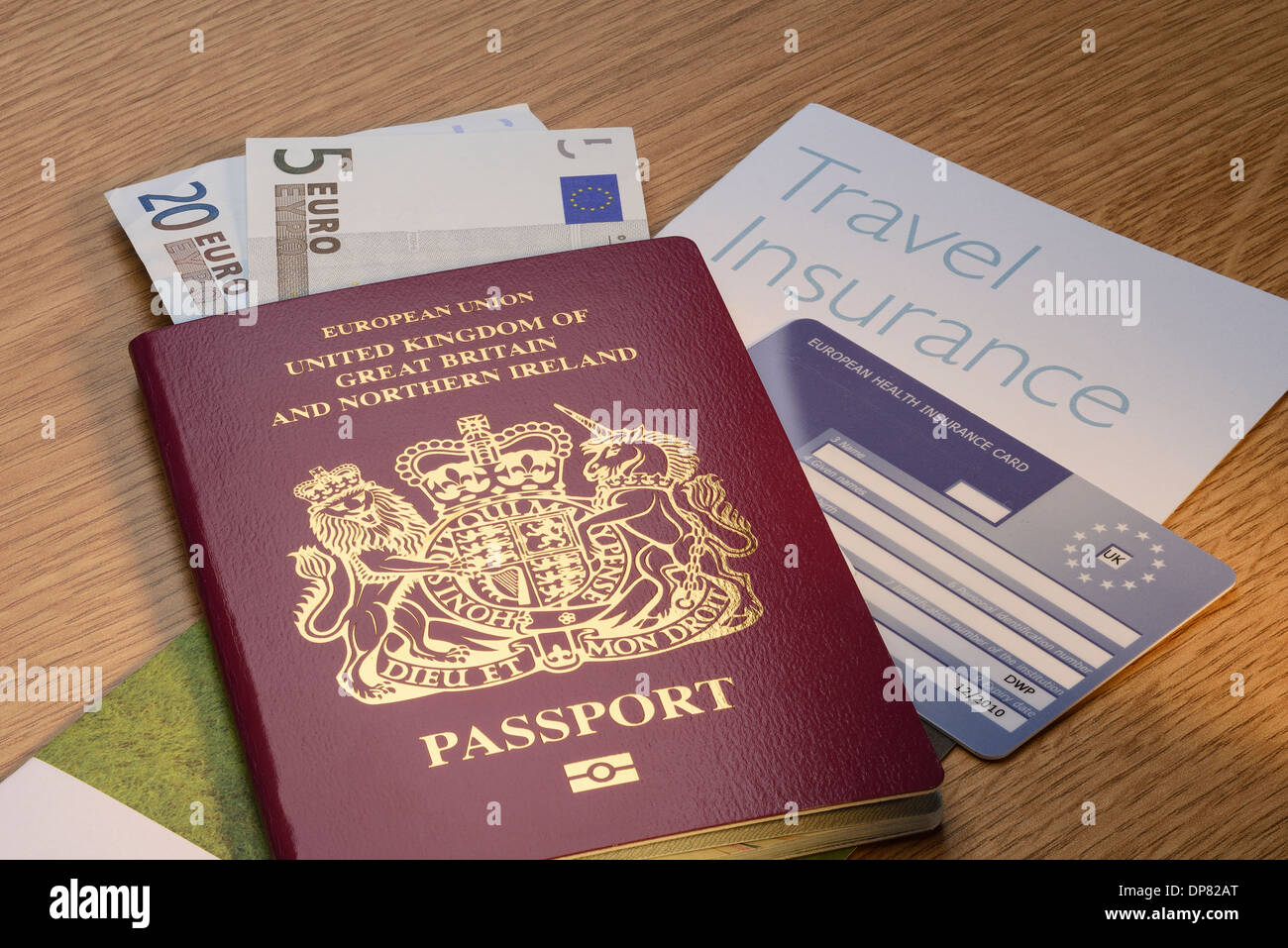 UK British passport with Euro money and travel insurance and an EHIC card Stock Photo