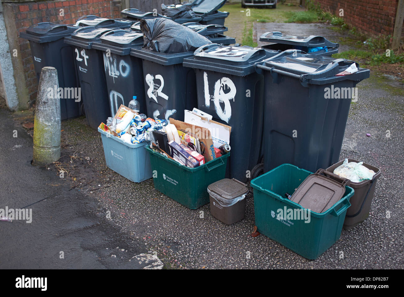 Bins and rubbish at the side of the road waiting for collection Stock Photo