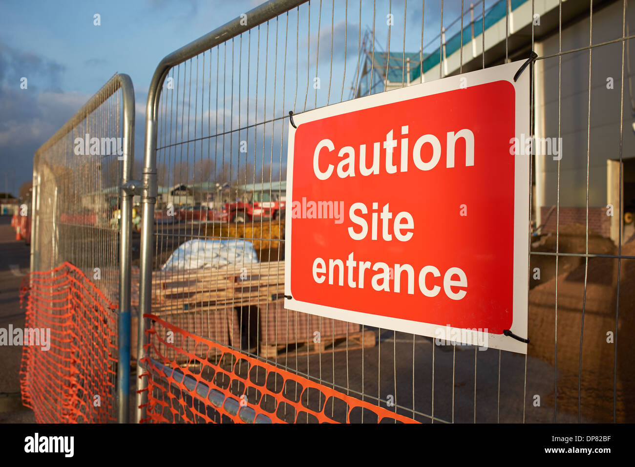 Caution Site Entrance notice of the fence of a building site Stock Photo