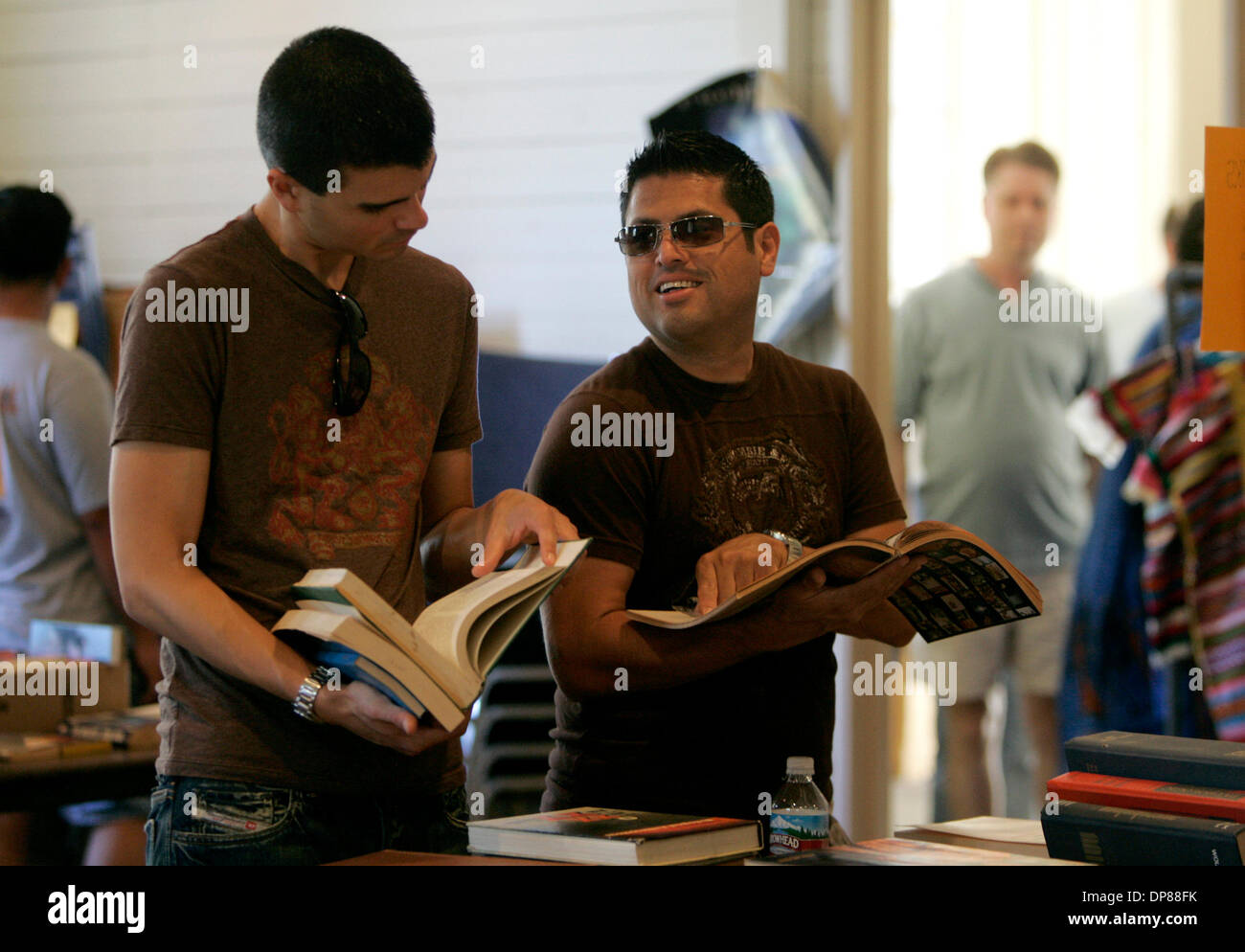 (Published 8/27/2006, B-5:R,C,CO)  August 26, 2006, San Diego, California ANDRE BEAUCHAMP, of Hillcrest, left, and RUBEN PACHECO, of North Park, right, laugh as they look through old books from a collection of items available for sale at the Museum of Man in San Diego's Balboa Park Saturday. Mandatory Credit photo by Laura Embry/San Diego Union-Tribune/Zuma Press, copyright 2006 Sa Stock Photo
