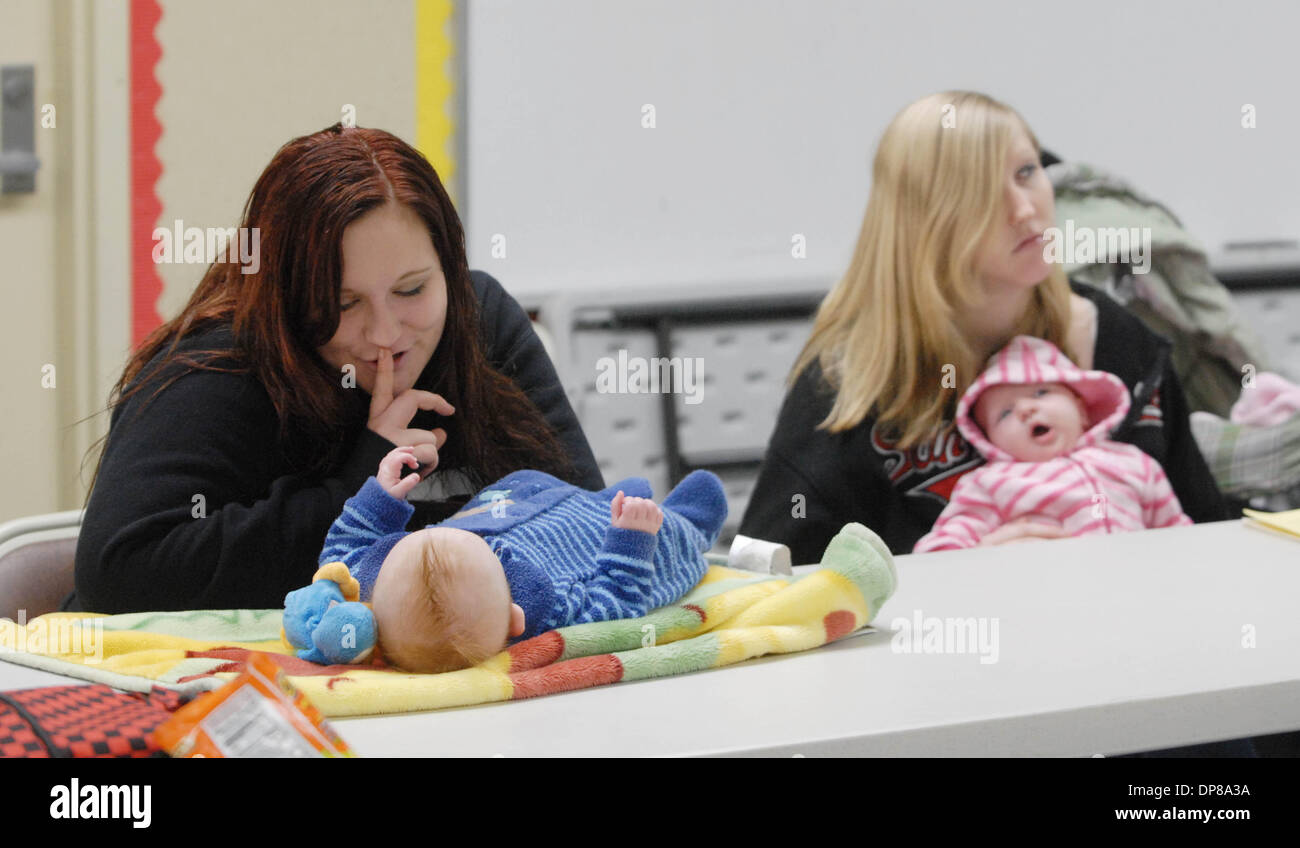 Sixteen year-old Ashley Goble, left, tries to calm her 4 month-old son, Aidan Garner during a teen pregnancy and parenting class at Independence High School in Brentwood, Calif., on Monday, November 26, 2007. At right is 17 year-old Angela Poirier with a sleepy 4 week-old, Sophie Poirier. Teen birth rates in East County  is higher than the county average. The alarming trend may ind Stock Photo