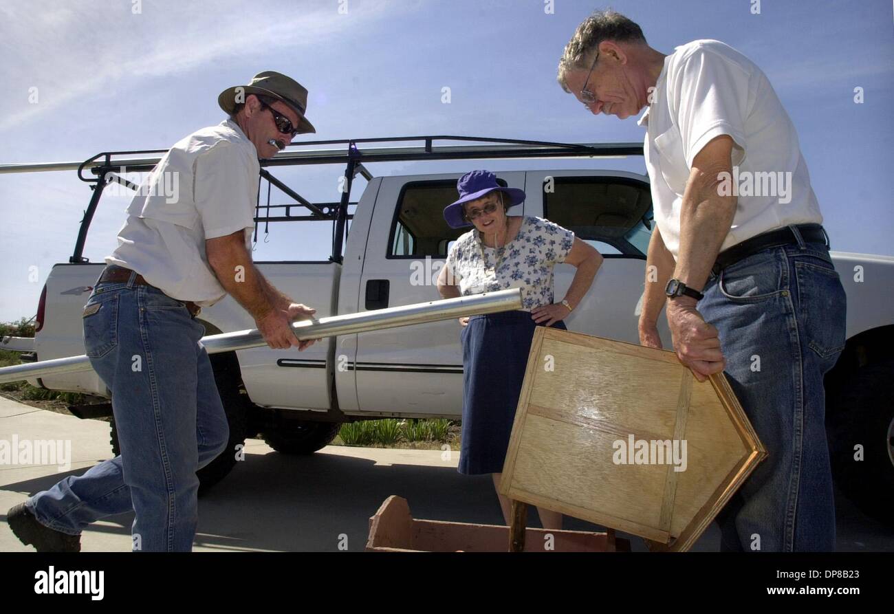 (published 05/30/2004, Ed. N; UTS1810935) TOM STEPHAN, at left, prepares to attach a 16 foot long pole to the owl house chosen by JAMES CHURCHYARD (assisting, at right) and ALBERTA JANE PARKER (watching) that will be mounted next to there home.  U/T photo CHARLIE NEUMAN Stock Photo