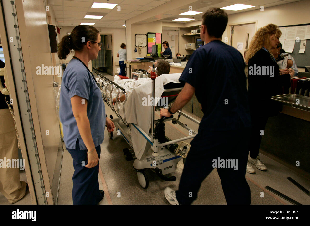 (Published 6/6/2006, A-6) June 5, 2006, San Diego, CA. USA. JEN ARMSTRONG, RN, left, watches a patient being wheeled in to UCSD Medical Center's Emergency Room in HIllcrest on Monday afternoon. Starting July 1, Medi-Cal patients will be required to show proof of citizenship to enroll in the program. Documents include passports, birth certificates and citizenship certificates. Some  Stock Photo