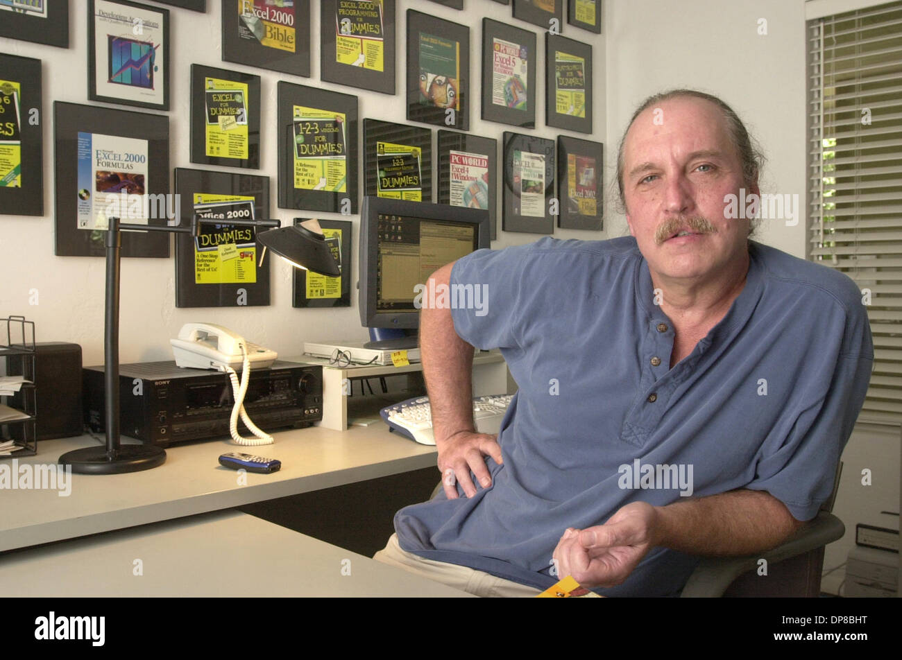 (Published 09/22/2003, C-1) Portrait of JOHN WALKENBACH in his home office. On the wall behind him are framed covers of the various computer books he's authored, most of them are the popular Dummies books.  U/T photo CHARLIE NEUMAN Stock Photo