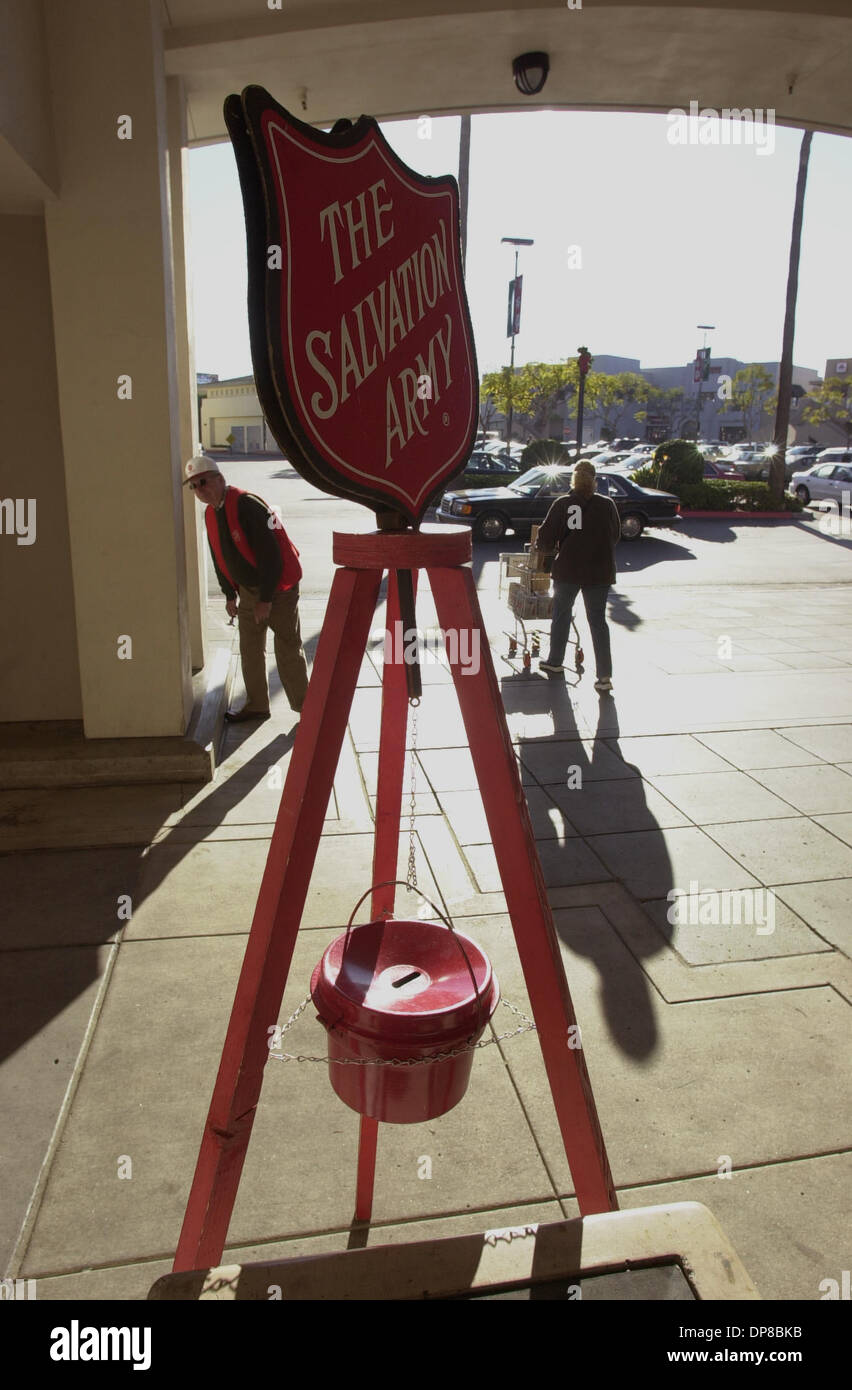 (Published 12/27/2003, C-1; UTS1779935) The Salvation Army collection bucket sits outside the Ralphs store in Hillcrest. The bell ringing volunteer, Odell Foley is seen in the background to the left of the sign. He was greeting shoppers near the store.UT/DON KOHLBAUER Stock Photo