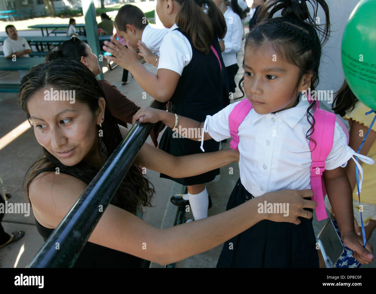 (Published 9/24/2005, B-1:6) Brenda Rodriguez adjusts her daughter Ingrid Carrera, 4,'s uniform outside the auditorium at Willow Elementary School in San Ysidro Thursday afternoon for the fashion show on Back Stock Photo