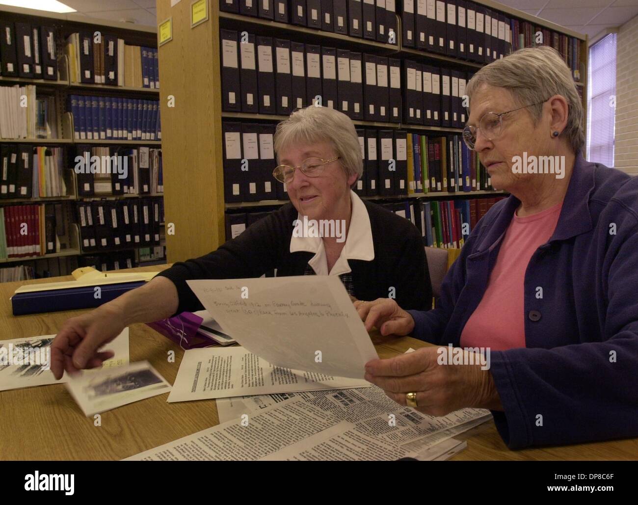 (Published 5/26/2004, NC-3, NI-3, UTS1809952) Ruth Collings (left) and Lucy Berk (right) went over possible photos for the 2005 Pioneer Room Historical Calendar. They were visiting the Pioneer Room, which is a research and archive center at the Escondido Library. If the budget cut proposal being voted on by the Escondido City Council passes, it will reduce the hours of operation at Stock Photo