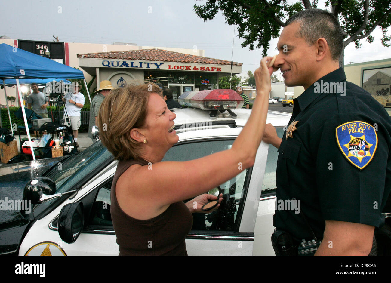 (Published 7/1/2006, NC-3, NI-3; B-5:C; B-7:E) June 27, 2006, Vista, California L.A. County Sheriffs Deputy PETE ENCISO, here acting in the video being produced, has final touches of makeup applied on his face by makeup artist DEB MEDINA GARCIA prior to shooting a scene  photo by Charlie Neuman/San Diego Union-Tribune/Zuma Press. copyright 2006 San Diego Union-Tribune Stock Photo