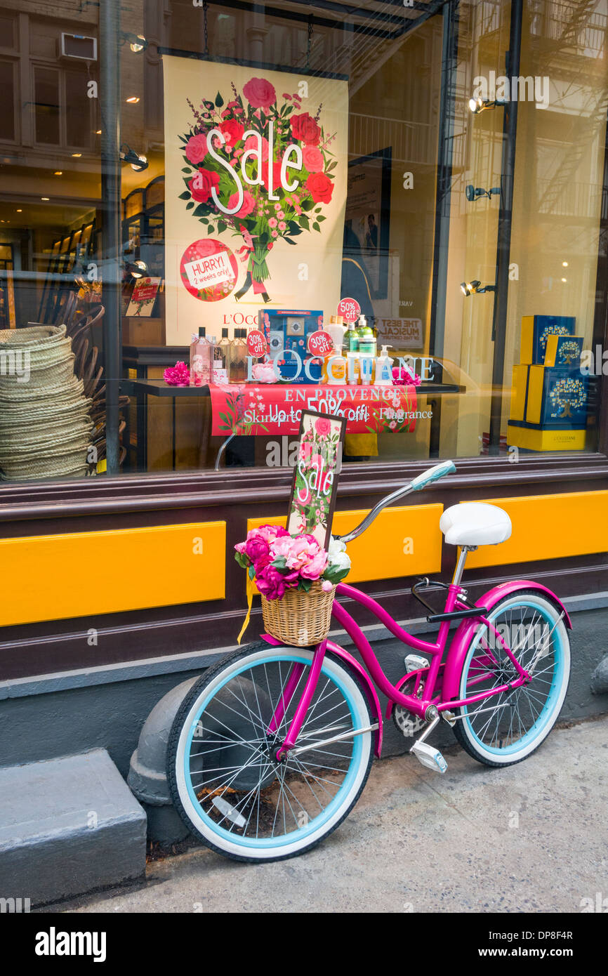 Colorful girl's bike outside shop Stock Photo