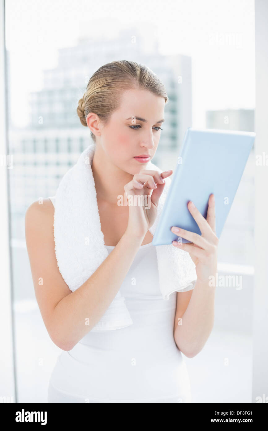 Focused sporty woman using tablet pc Stock Photo