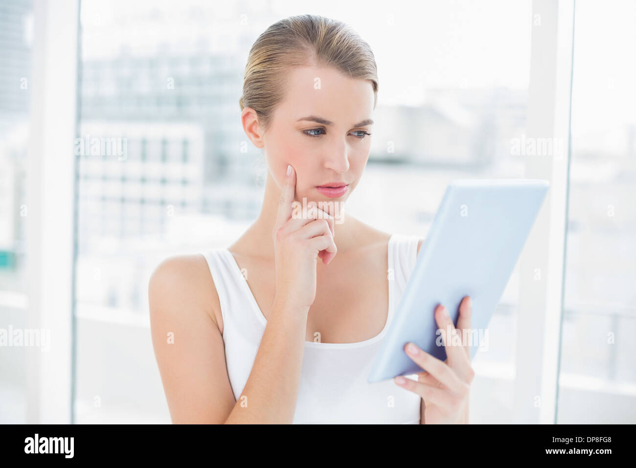 Focused sporty woman using tablet computer Stock Photo