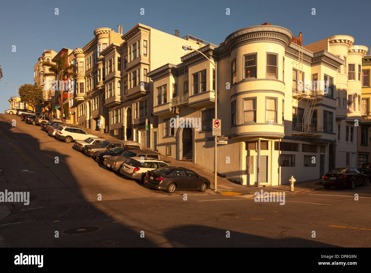 Victorian houses Illuminated by the warm afternoon sun on the corner of Kearny and Green Street,Telegraph Hill,San Francisco,Cal Stock Photo