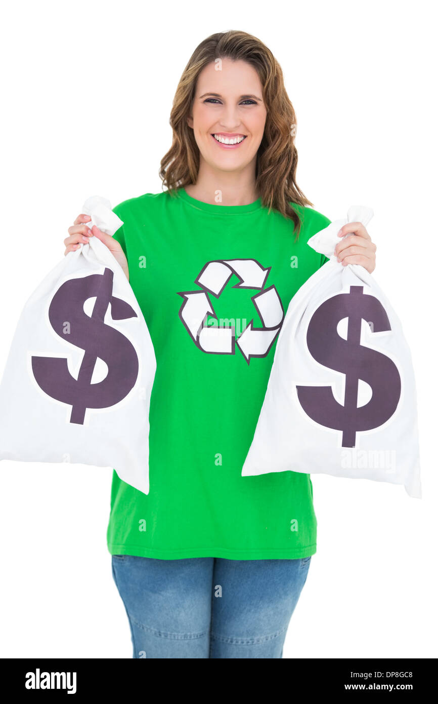 Smiling environmental activist holding money bags Stock Photo