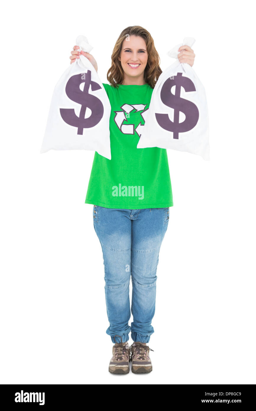 Smiling environmental activist holding money bags looking at camera Stock Photo