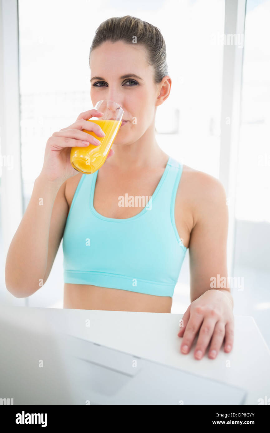 Woman wearing sportswear drinking orange juice Stock Photo