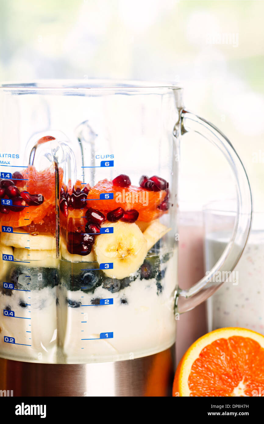 Closeup of healthy smoothie ingredients in blender with fresh fruit