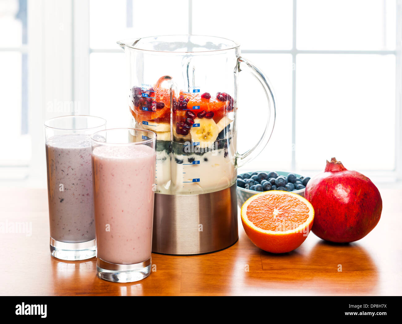 Prepared smoothies and healthy smoothie ingredients in blender with