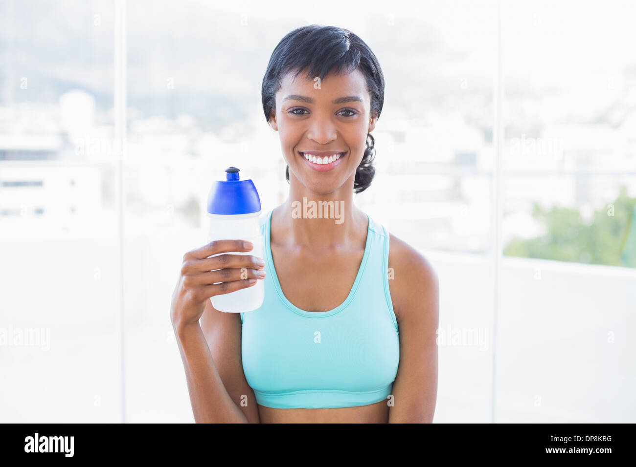 Happy fit woman holding a bottle of water Stock Photo - Alamy