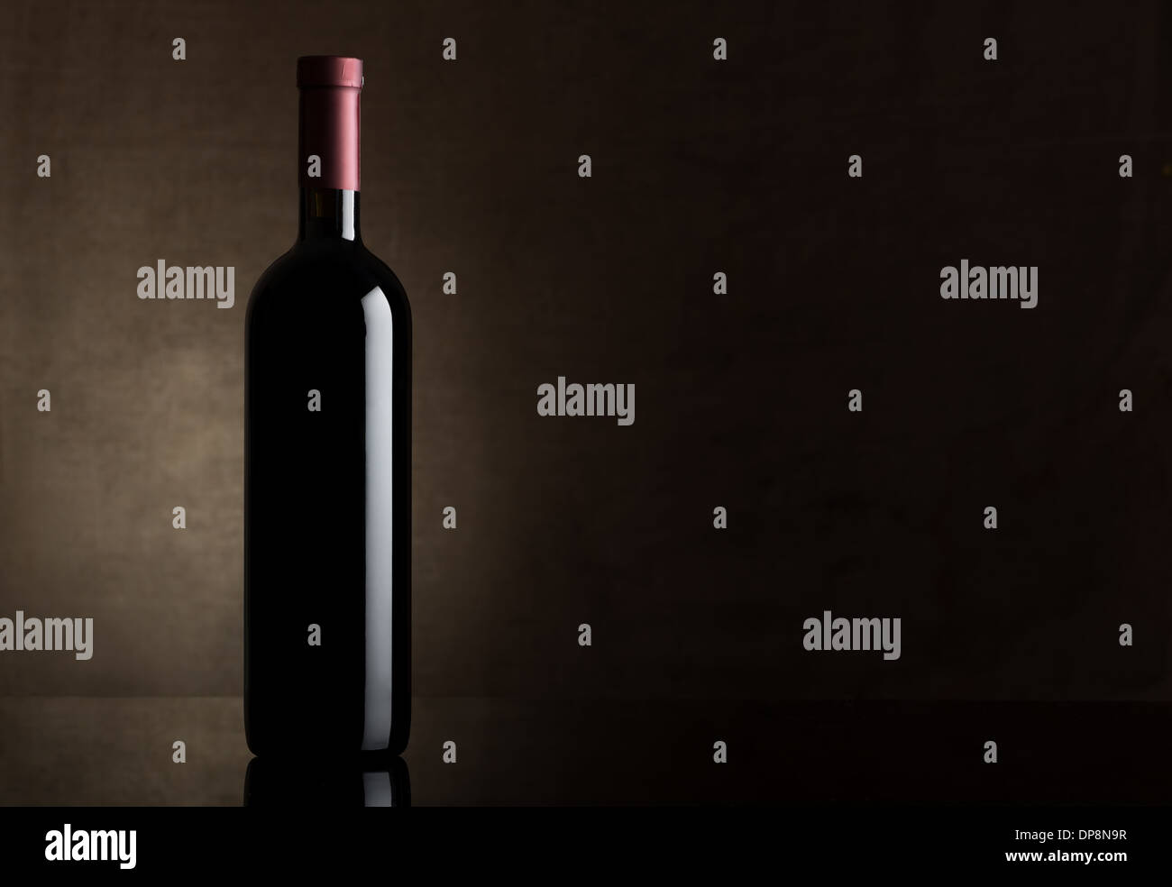 Black bottle of wine on a dark background Stock Photo