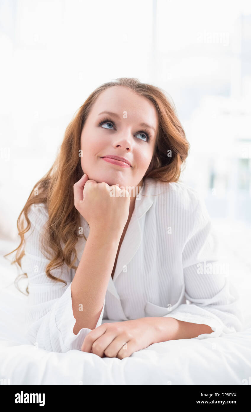 Thoughtful pretty woman lying on her bed Stock Photo - Alamy