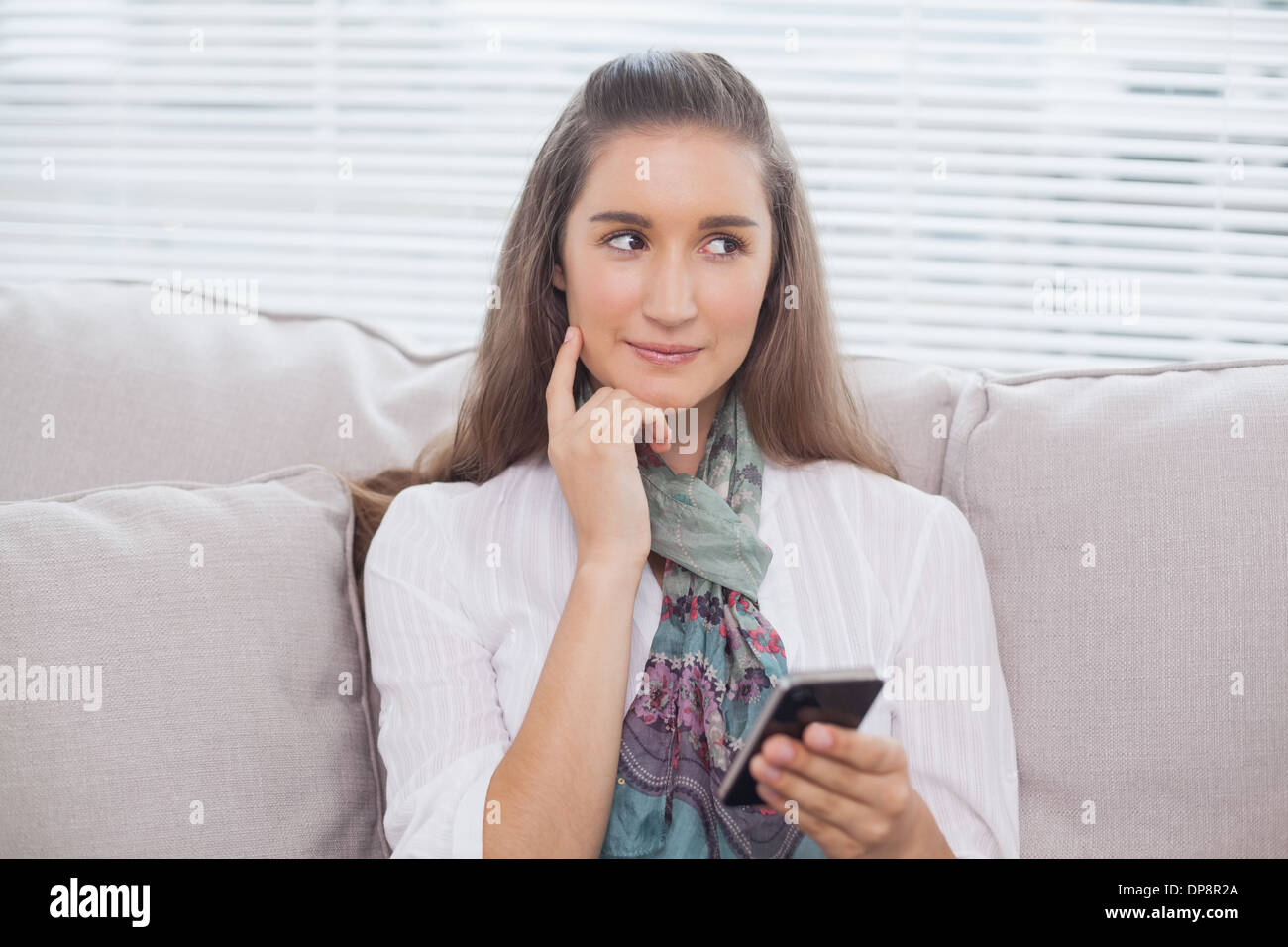 Pensive pretty model text messaging Stock Photo