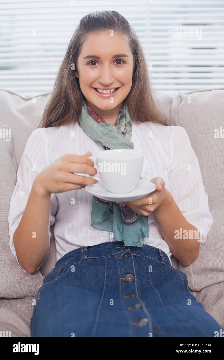 Happy pretty model holding coffee Stock Photo