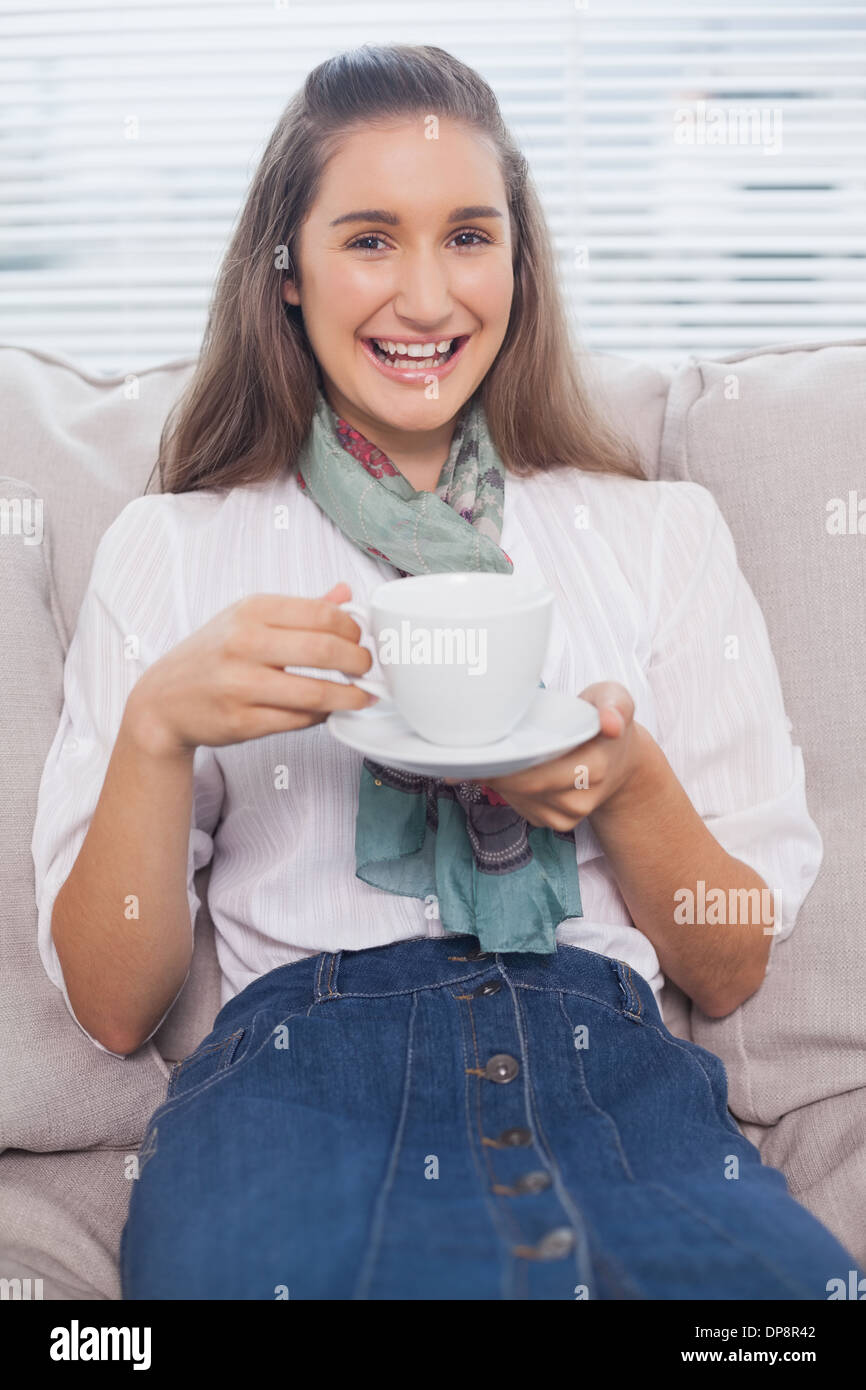 Smiling pretty model holding coffee Stock Photo