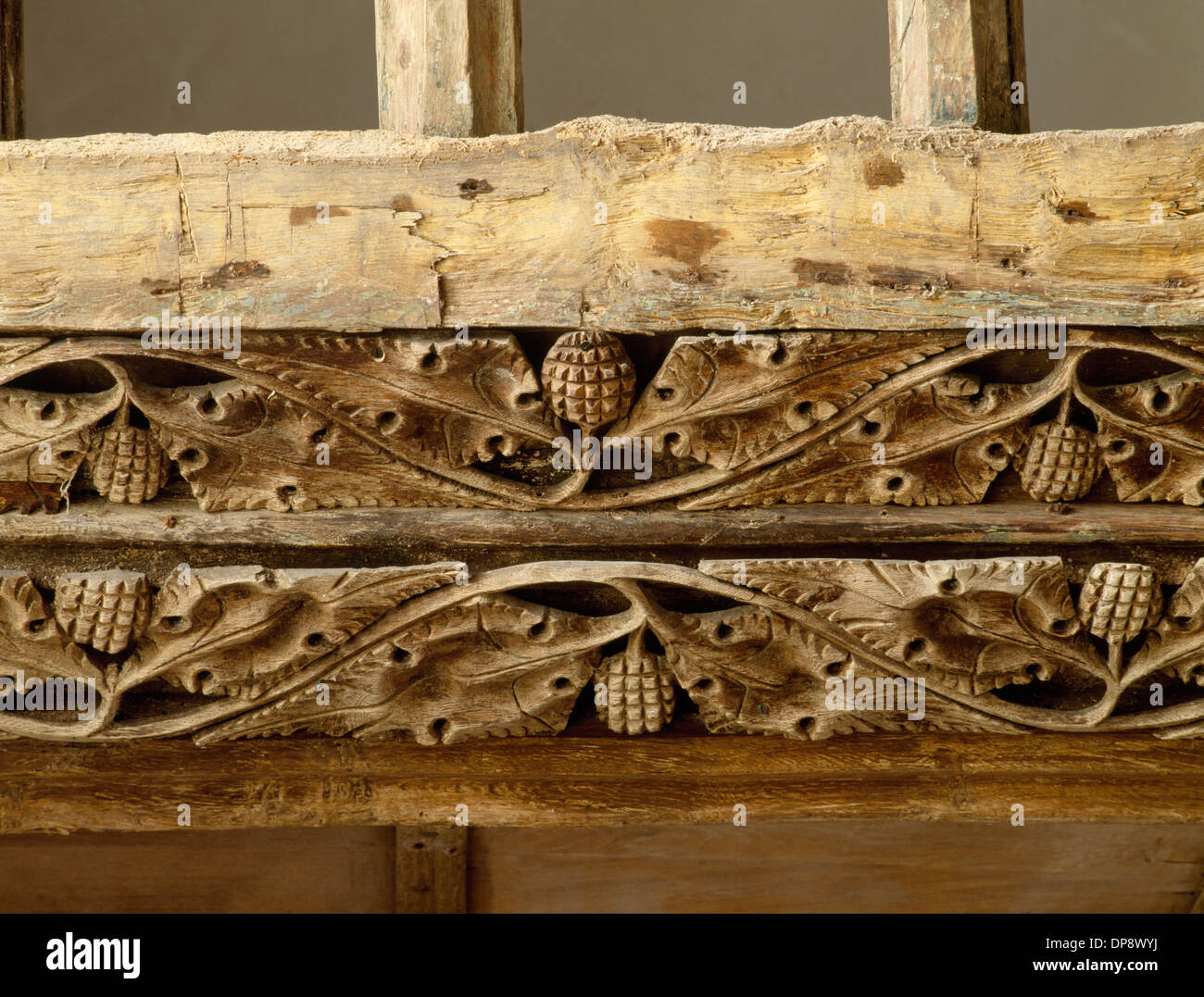 Detail of pierced vine scrolls on oak beam between the rood loft and screen (1495) in St Eilian's Church, Llaneilian, Anglesey. Christian symbolism. Stock Photo
